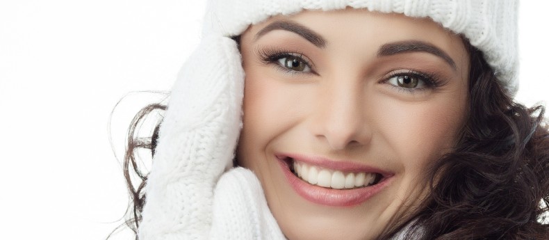beautiful woman in warm clothing on white background