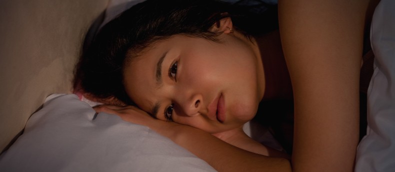 Young asian woman suffering from insomnia at home in bedroom