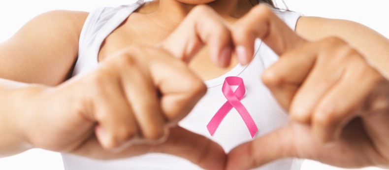 Heart Framing On Woman Chest With Pink Badge To Support Breast C